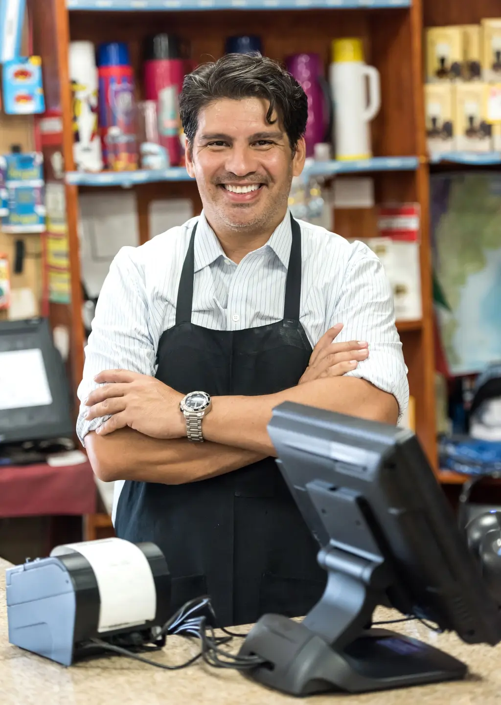 Smiling small business owner at the counter of his store, the kind of business LEMEICO advises on accounting and legal matters