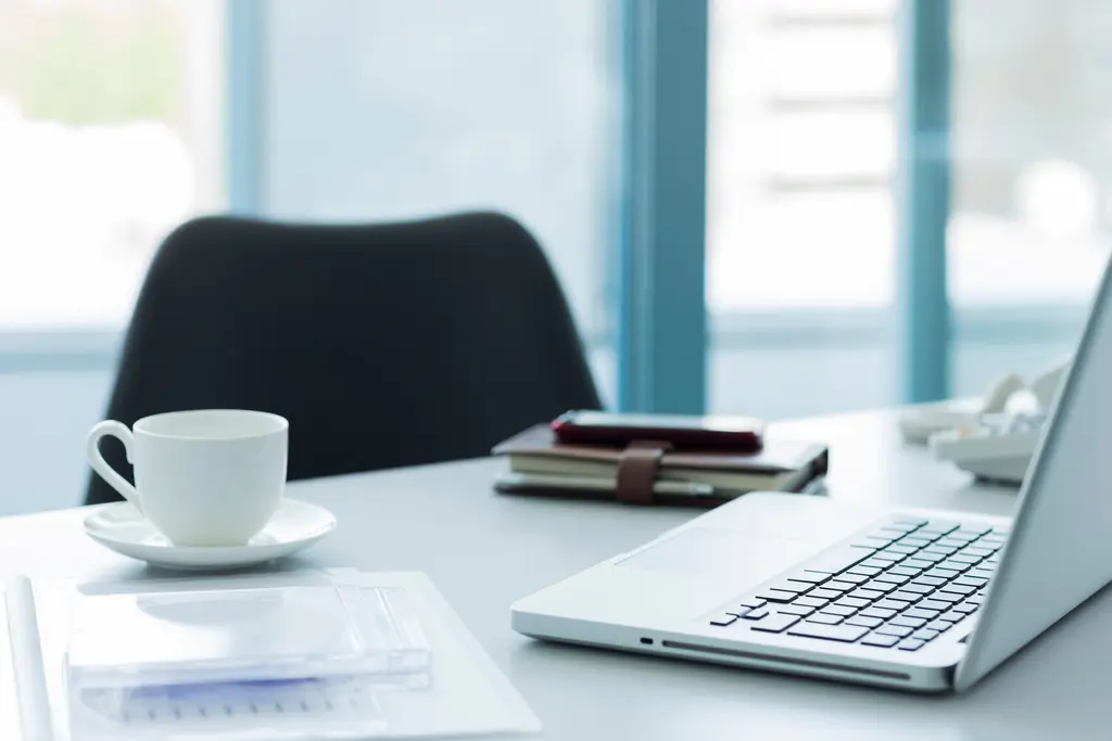 Office desk with a laptop and planner: outsourced accounting, tax and payroll for companies in Peru